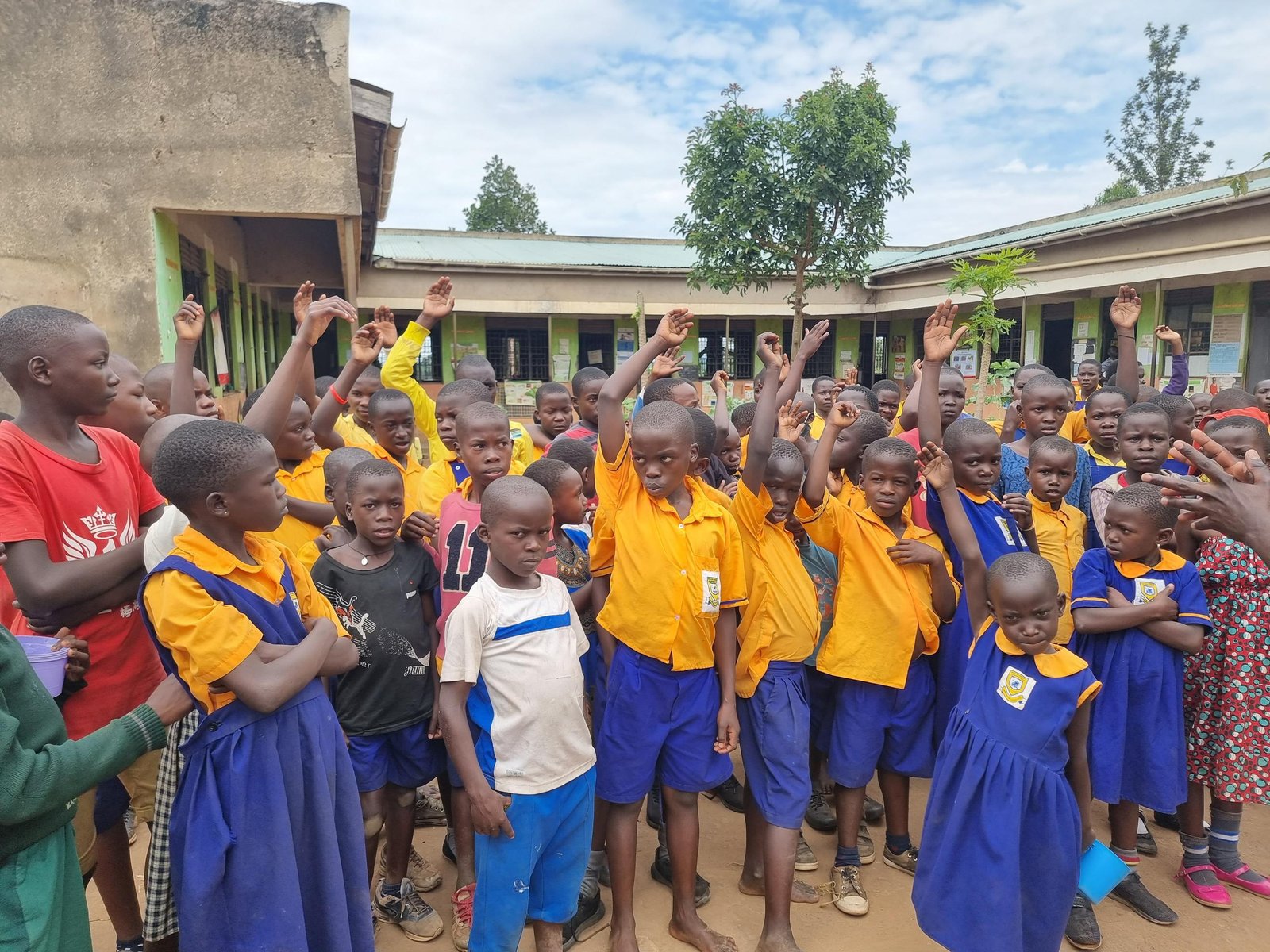 Happy children standing outside their safe dormitories